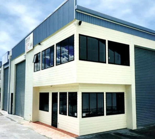 Freshly washed two-story commercial building with roll-up bays